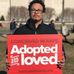 ryan-holding-adopted-and-loved-sign-mfl2018