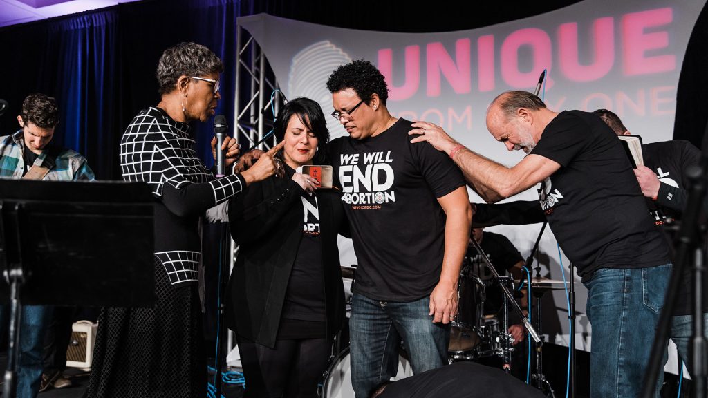 Catherine Davis and Lou Engle pray over Ryan and Bethany Bomberger at OneVoiceDC.